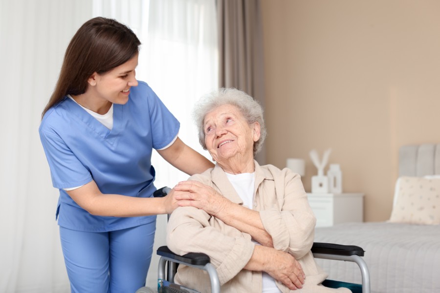 Nurse providing compassionate care to elderly resident
